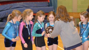 The team from Castle Camps are presented with the winners shield.