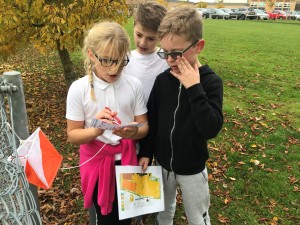 Children finding a control marker in the orienteering